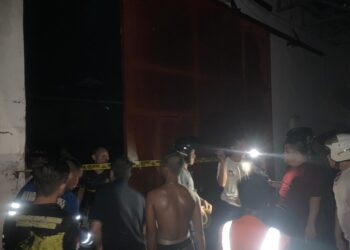 PETUGAS dari Polsek Banjarmasin Barat saat memasang garis polisi di gudang yang terbakar di Jalan Belitung Darat.