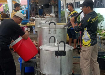 Sejumlah relawan taruna siaga bencana (Tagana) saat memasak makanan untuk keperluan haul ke-4 KH Ahmad Zuhdiannoor atau Abah Haji di STKIP Sabilal Muhtadin Banjarmasin.