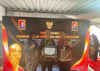 SEKDA Tapin H Sufiansyah di dampingi Kadis Kesehatan H Alfian Yusuf saat menerima penghargaan UHC Kategori Madya dari Pemerintah Pusat, Kamis (8/8).