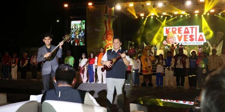 Sekdaprov Kalimantan Selatan, Roy Rizali Anwar bersama Deputi 1 Bidang Pemberdayaan Pemuda, Kemenpora, Dr Asrorun Ni’am Sholeh memetik alat musik panting sebagai tanda dibukanya Kreativesia Nasional Tahun 2024 di Banjarbaru