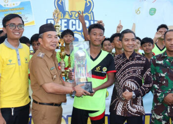 Pj Bupati Tapin M Syarifuddin MPd saat menyerahkan trophy juara Turnamen Sepakbola BRE CUP VI.