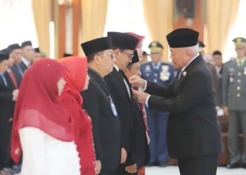 GUBERNUR Kalimantan Selatan, H Muhidin secara simbolis saat menyematkan tanda kehormatan satya lancana karya satya X, XX dan XXX dari Presiden kepada ASN di lingkungan Pemprov Kalsel, di Banjarmasin.
