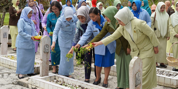 WAKIL Ketua I TP PKK Kotabaru Siti Hadijah Syairi Mukhlis bersama peserta saat menabur bunga di Taman Makam Pahlawan, Sabtu (13/12).
